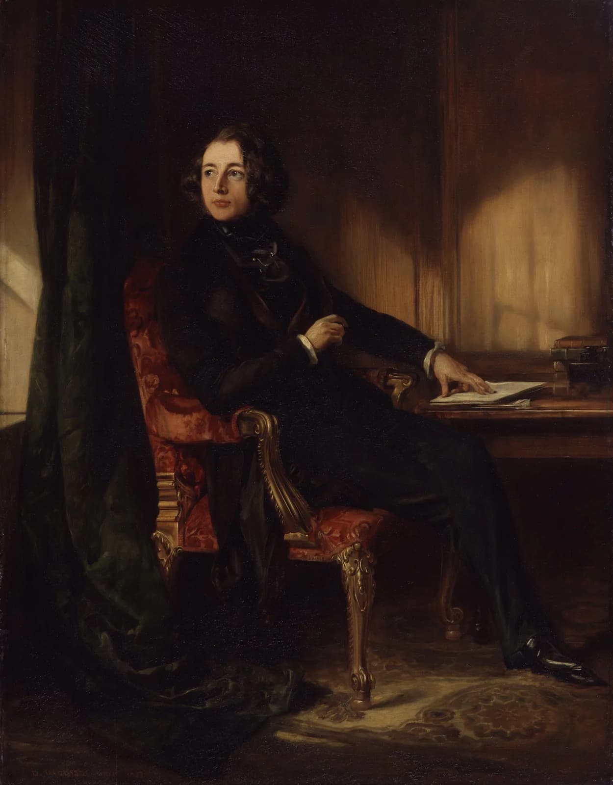 An oil portrait of Charles Dickens as a young man, seated at a writing desk with a manuscript in front of him, painted four years before A Christmas Carol