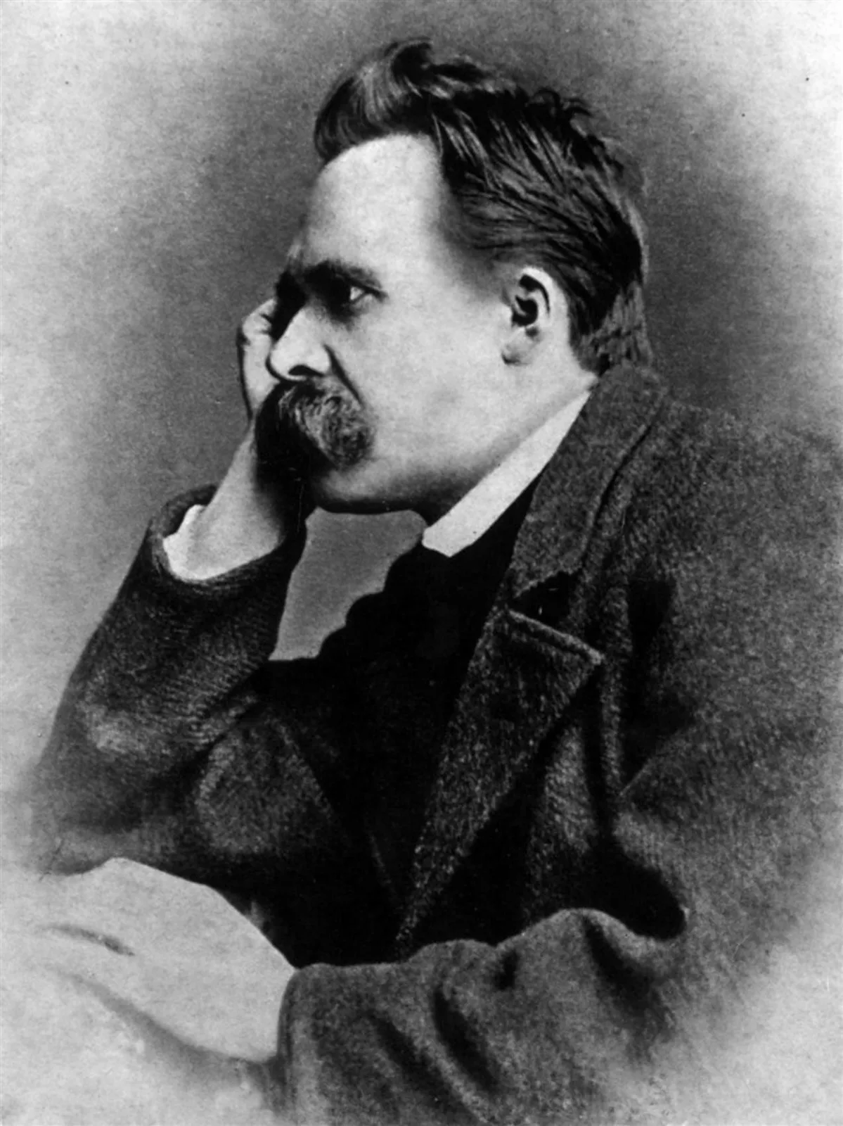 Gustav-Adolf Schultze's 1882 studio photograph of Friedrich Nietzsche in a dark coat, seated, looking away from the camera