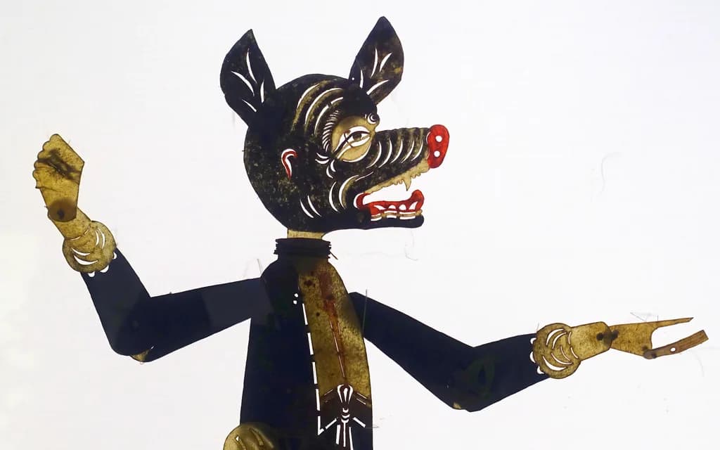 A Qing-dynasty cowhide shadow-puppet figure of Zhu Bajie, the pig-headed pilgrim, painted in black and gold