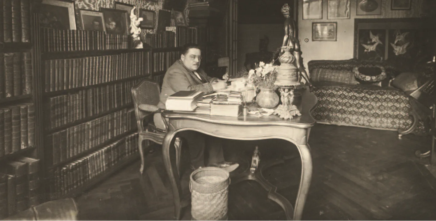 A photograph of the novelist Gaston Leroux seated at his writing desk in Nice, taken about 1919, from the Bibliotheque nationale de France's Leroux papers
