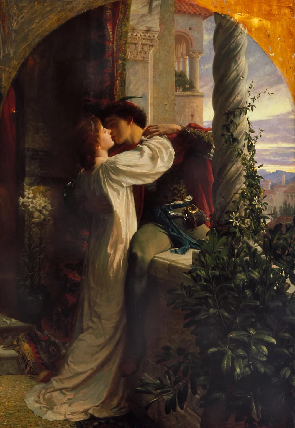 Frank Dicksee's 1884 painting of the balcony scene: a woman in a flowing white gown leans down from a stone balcony to kiss a young man in a red-caped doublet seated on the balustrade with a sword at his hip, framed by carved spiral columns, ivy and white lilies against a sunset sky