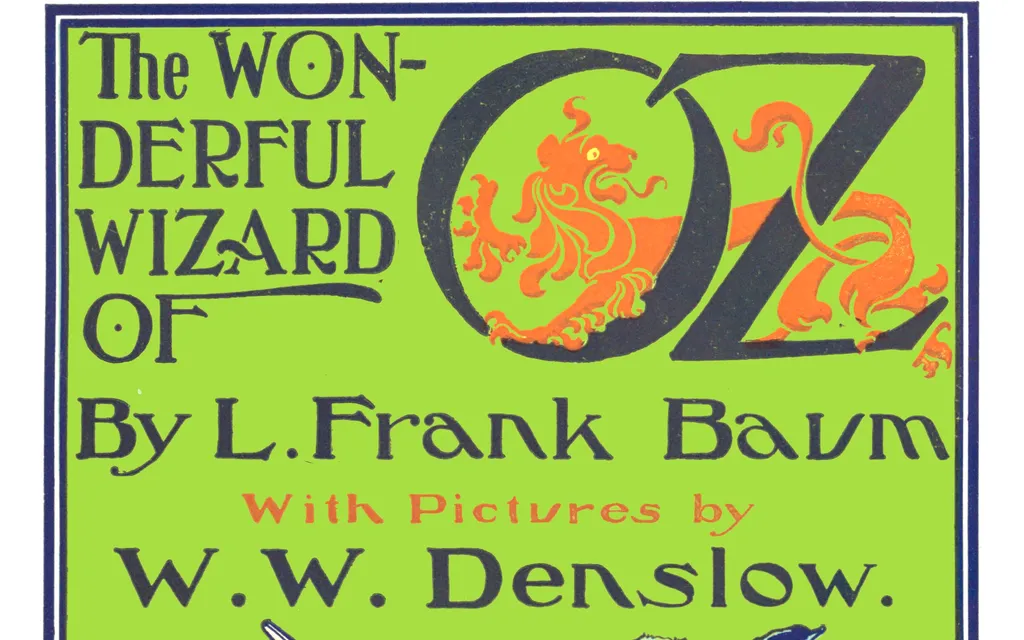 The green illustrated 1900 title page of The Wonderful Wizard of Oz, with an orange lion curled inside the O of OZ