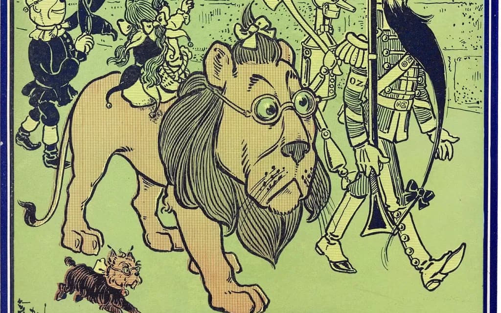 W. W. Denslow's 1900 plate of the Cowardly Lion in green spectacles carrying Dorothy through the Emerald City beside the Tin Woodman and the green-whiskered Soldier