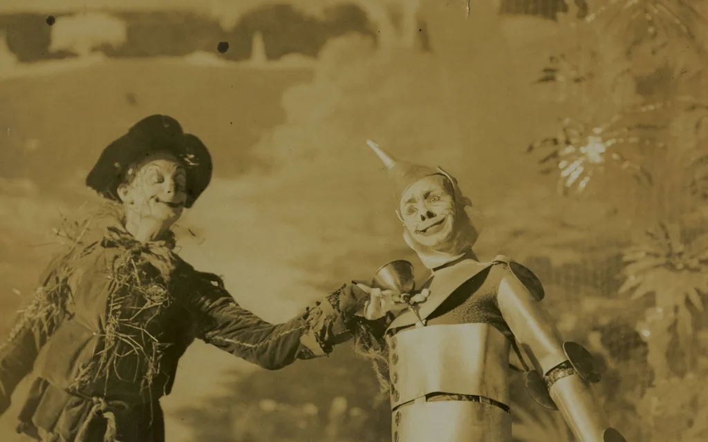 A 1904 stage photograph of the Scarecrow and the Tin Woodman shaking hands in the musical extravaganza The Wizard of Oz