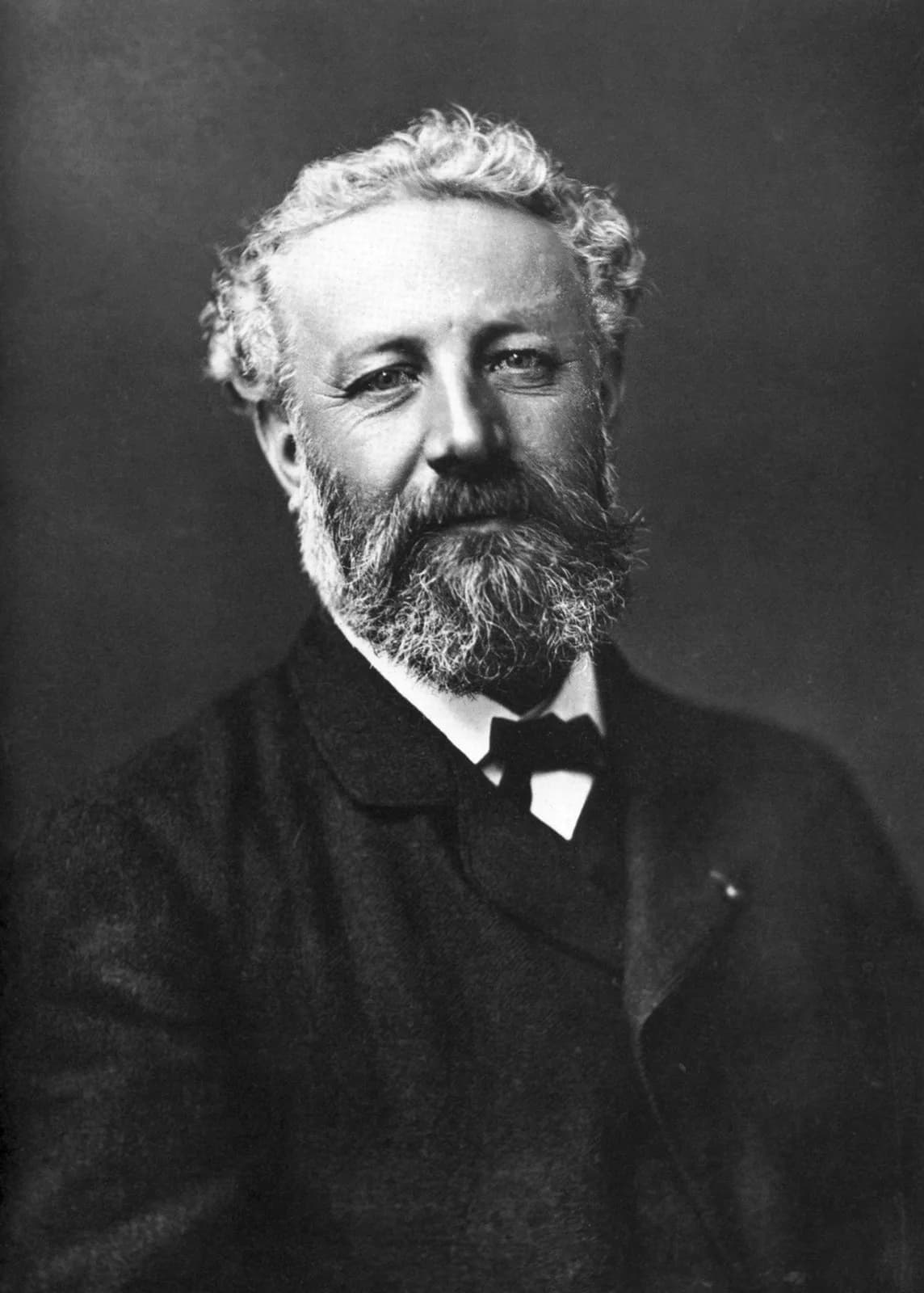 A photographic portrait of Jules Verne by Nadar, taken around 1878, showing the writer in a dark coat with a full beard